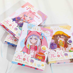 Flat lay of Brave Girl kawaii anime notebooks with magnetic buckle closure in pink, blue, and yellow pastel designs