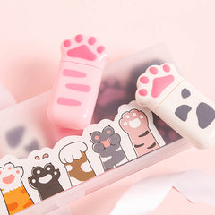 Cat paw correction tape dispensers beside a stationery case