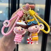 Pink and yellow summer doll keychains with braided straps