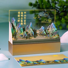 Layered mountain paper sculpture memo pad with scenic artwork and gold base