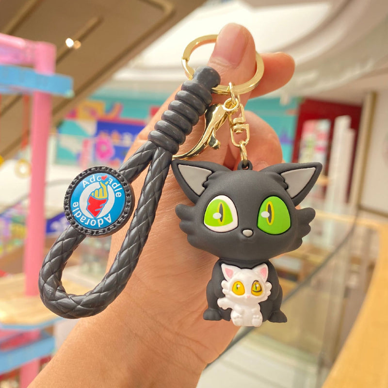 Black cat rubber keychain with black braided strap and gold-tone clasp