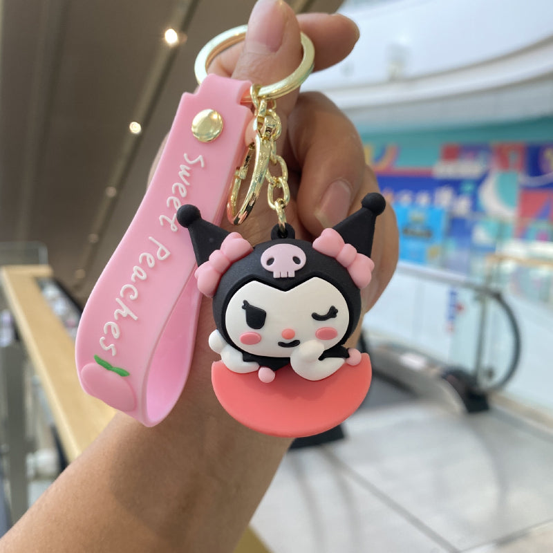 Black and pink character keychain with gold-tone hardware