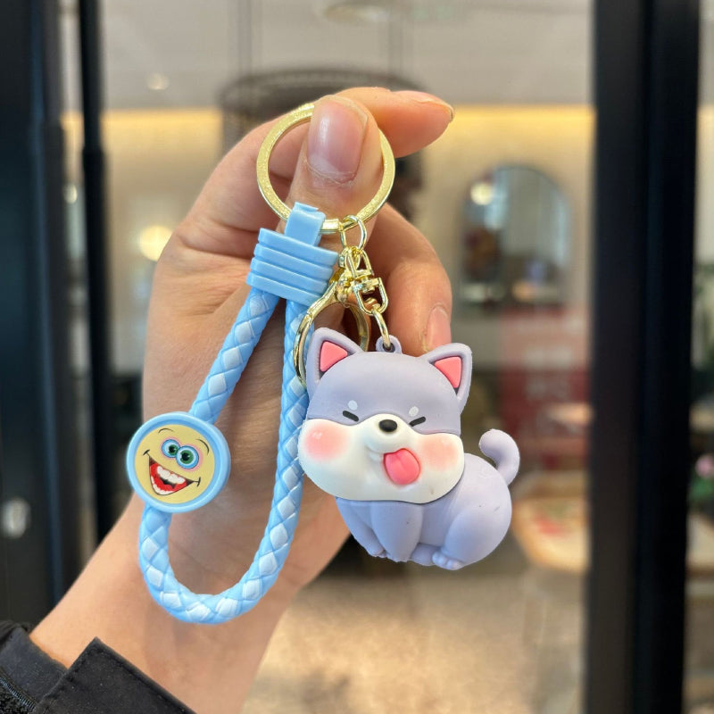Blue cute dog figurine keychain with braided strap and gold-tone ring