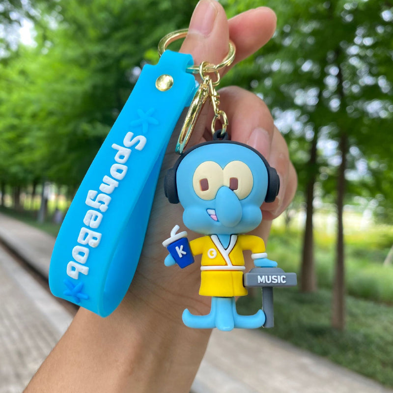 Blue elephant character keychain with headphones, outfit and metal ring