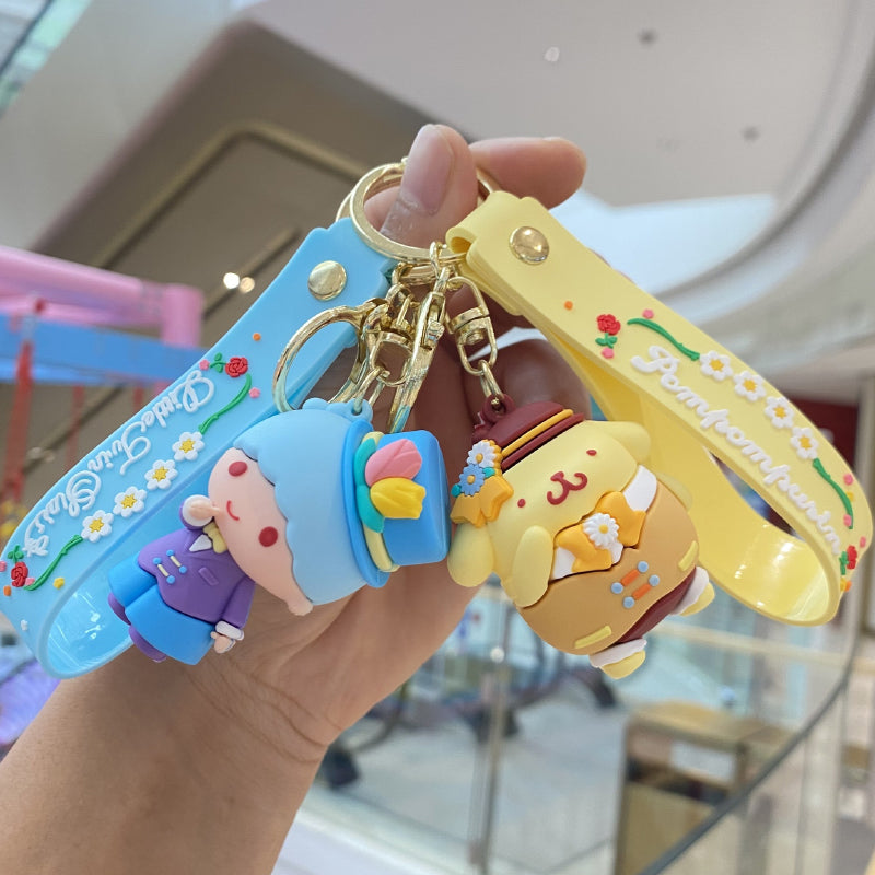 Blue and yellow doll keychains with floral decorative straps