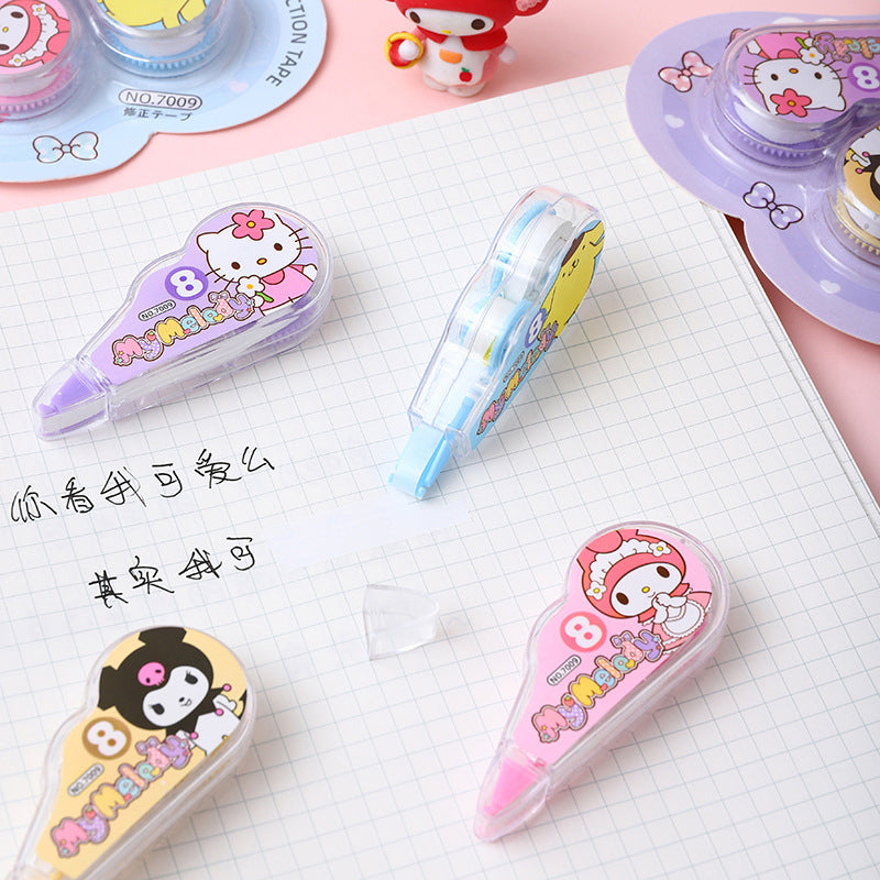 Cartoon correction tape dispensers placed on a grid notebook