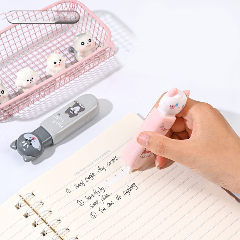 Pink cat correction tape being used on a notebook page