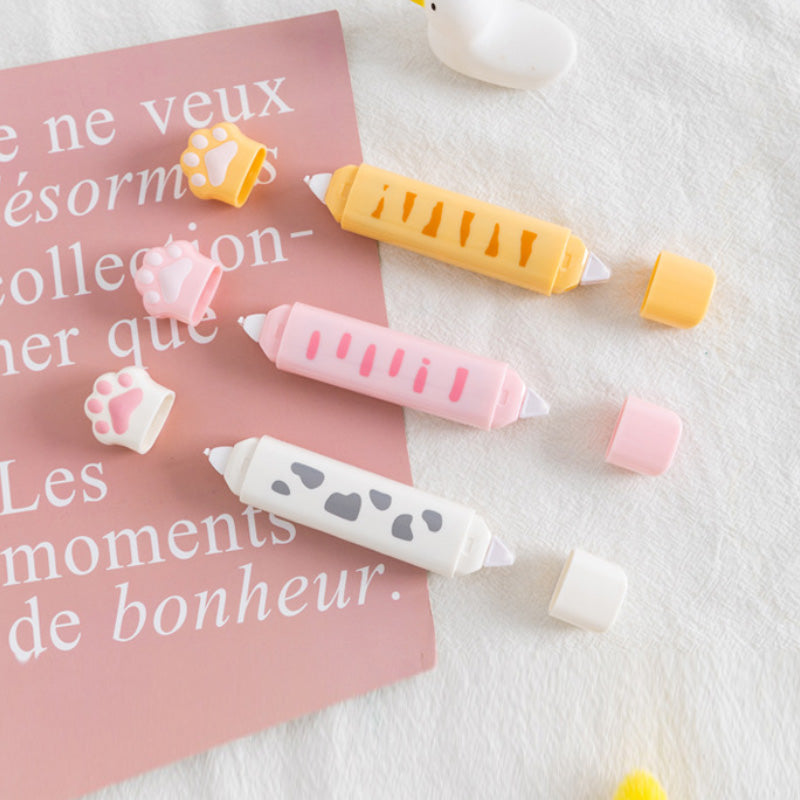 Cat paw correction tape dispensers in pink, white, and yellow