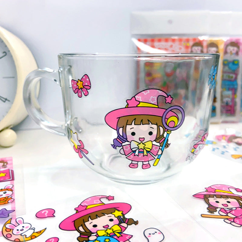 Clear glass cup decorated with waterproof cartoon stickers showing long lasting adhesion on smooth glass surfaces