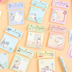 Pastel cute cat handbook notebooks arranged on a peach background