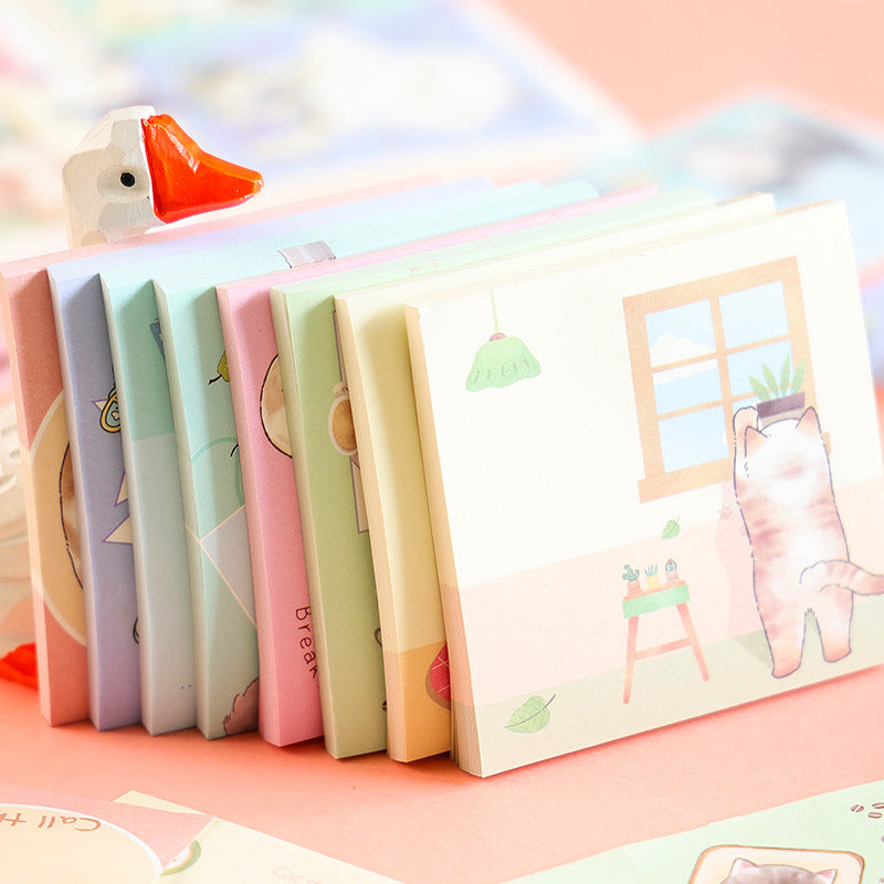 Stacked cute cat notebooks featuring colorful cartoon designs