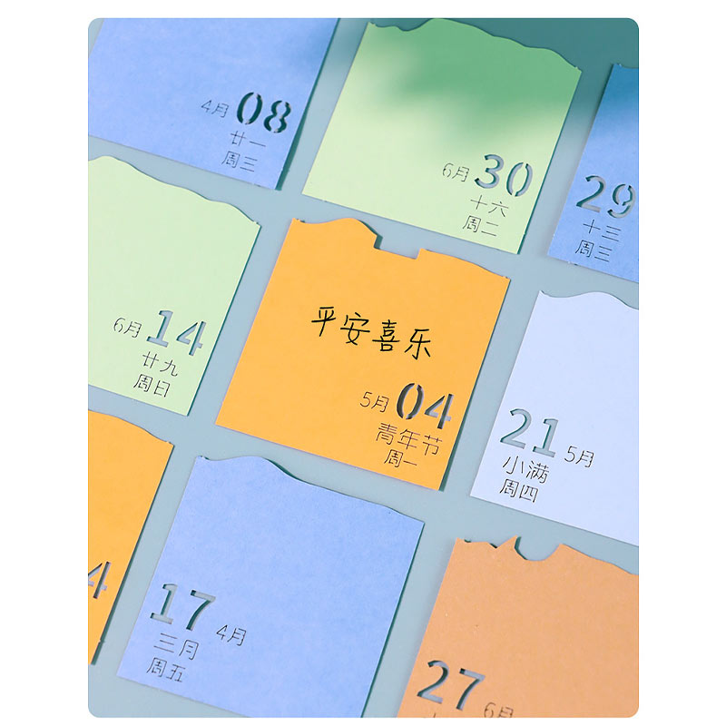 Colorful calendar note cards displayed beside a 3D paper landscape