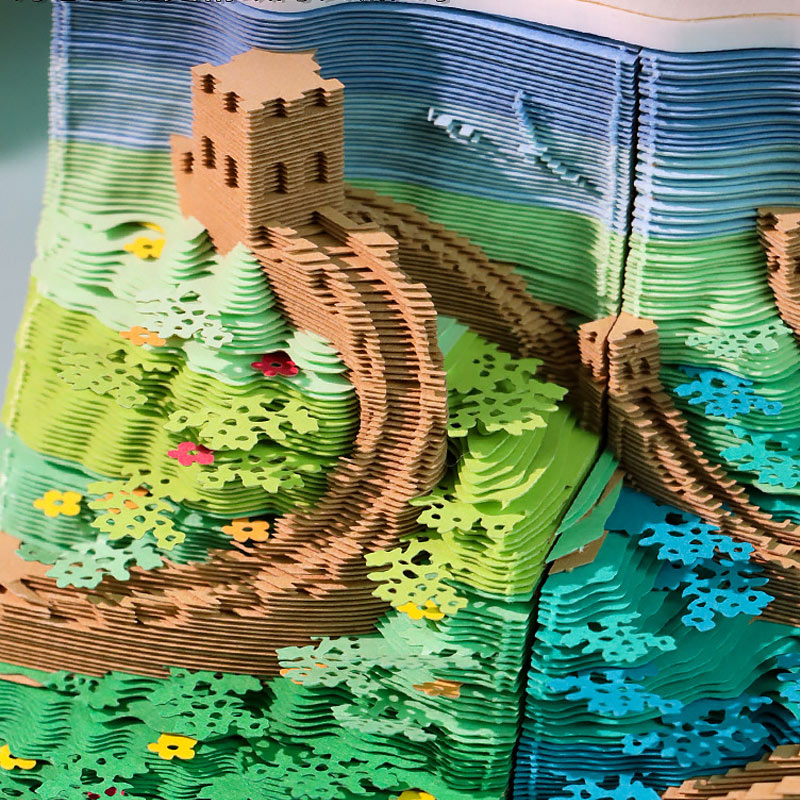Close-up of layered paper mountains, trees, and Great Wall details