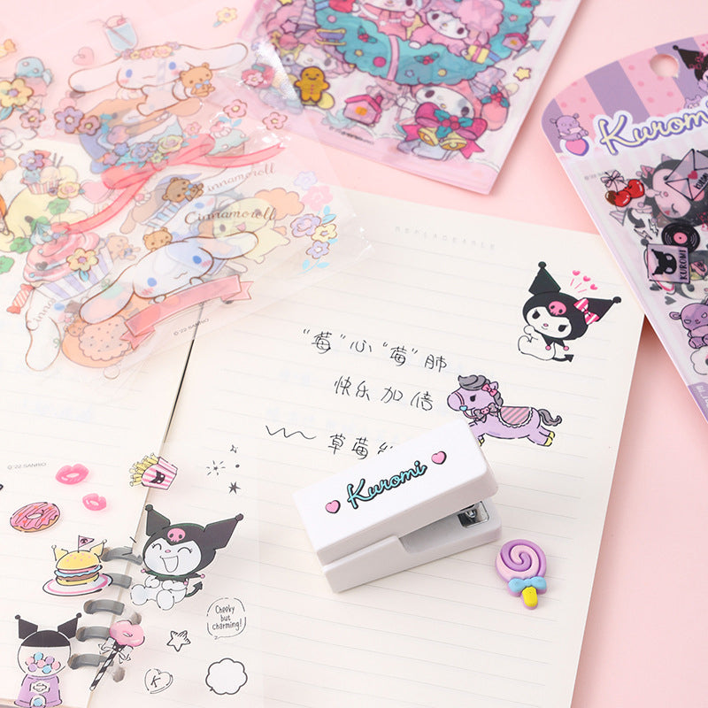Cute decorative sticker sheets displayed beside a notebook with pastel stationery accessories