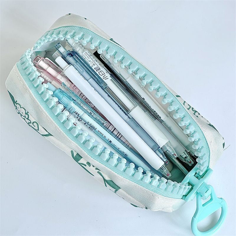 Large capacity canvas pencil case filled with pens, pencils, and everyday writing essentials