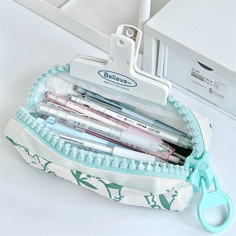 Large zipper pencil case opened to show spacious storage for pens, pencils, markers, and stationery supplies