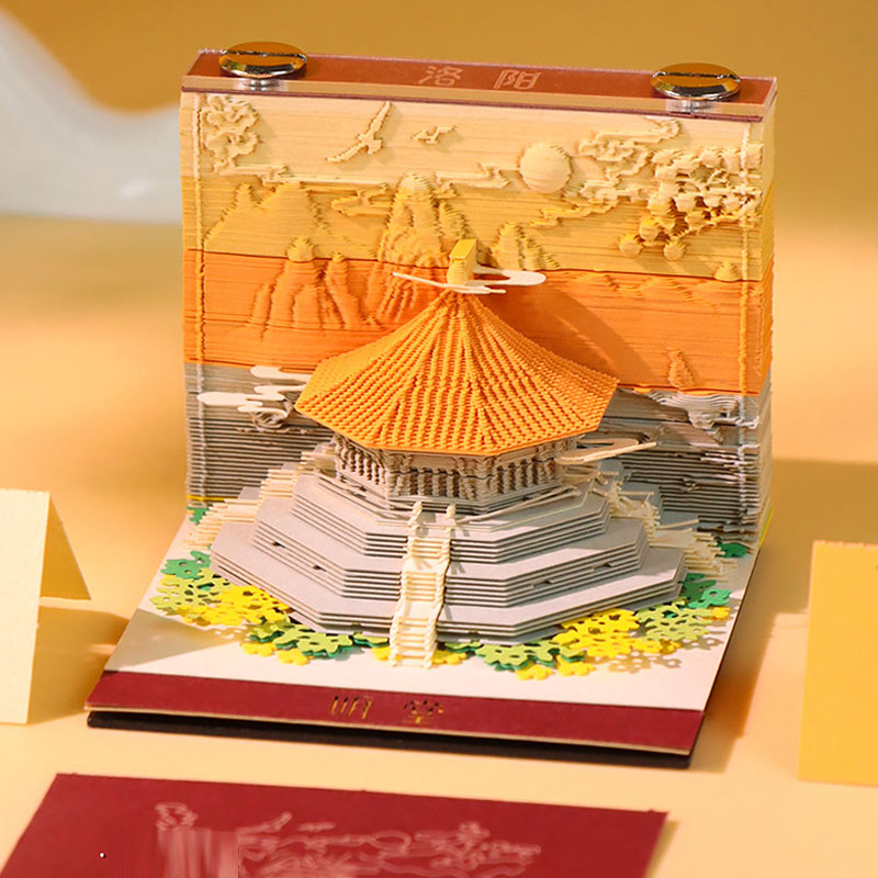 Layered architectural memo paper featuring a miniature scenic structure