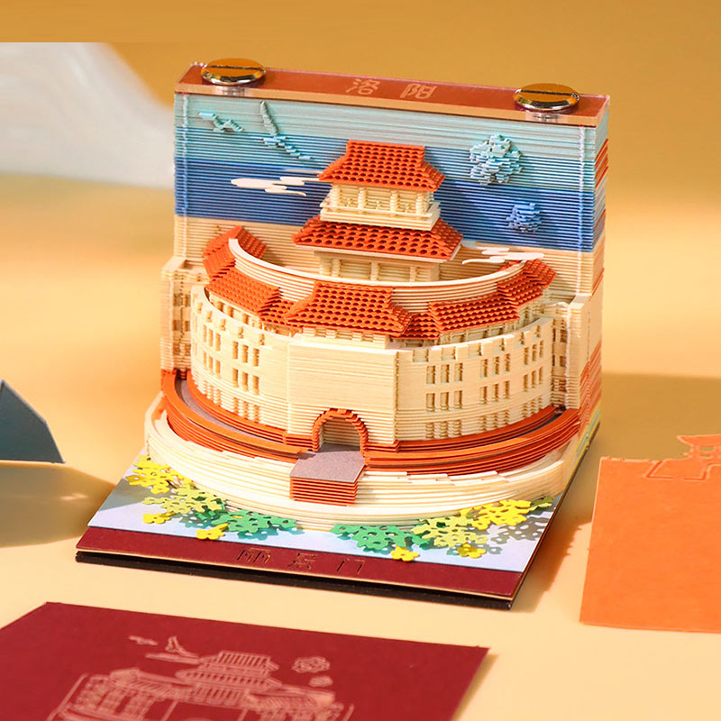 Layered scenic note paper arranged to showcase miniature landmark artwork