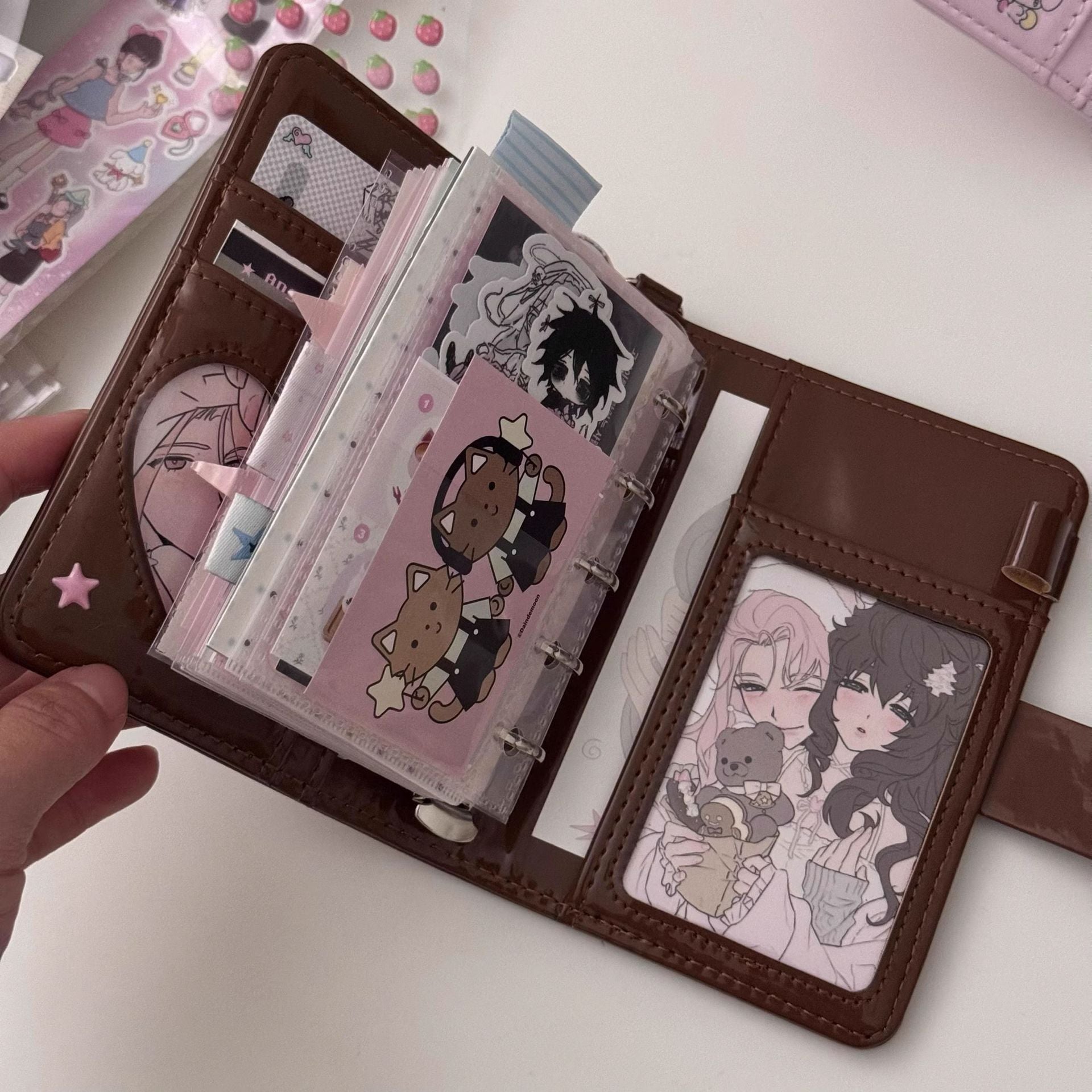 Open M5 chocolate brown PU planner with loose-leaf inserts, pockets and decorative journaling accessories