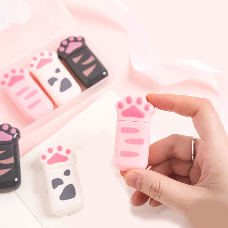 Pink cat paw correction tape dispenser held in hand