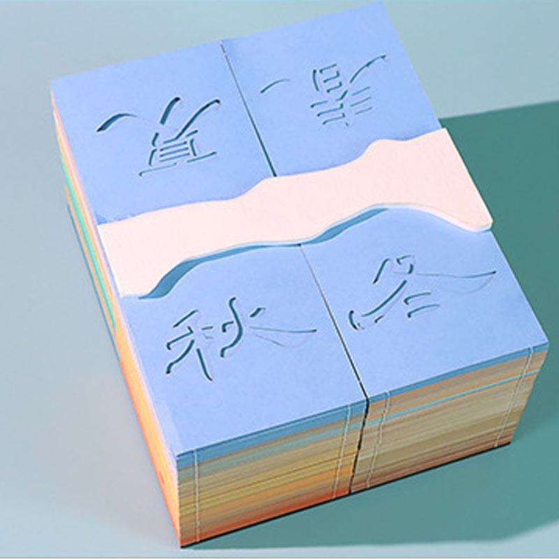 Top view of a colorful layered paper sculpture note pad