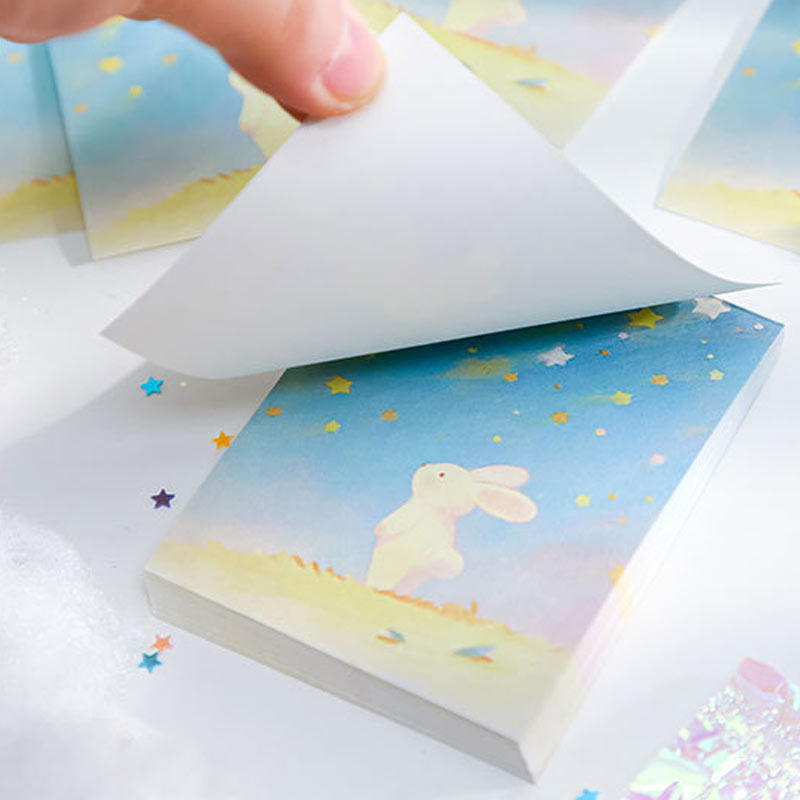 Pastel blue bunny notebook with stars and a soft dreamy sky background