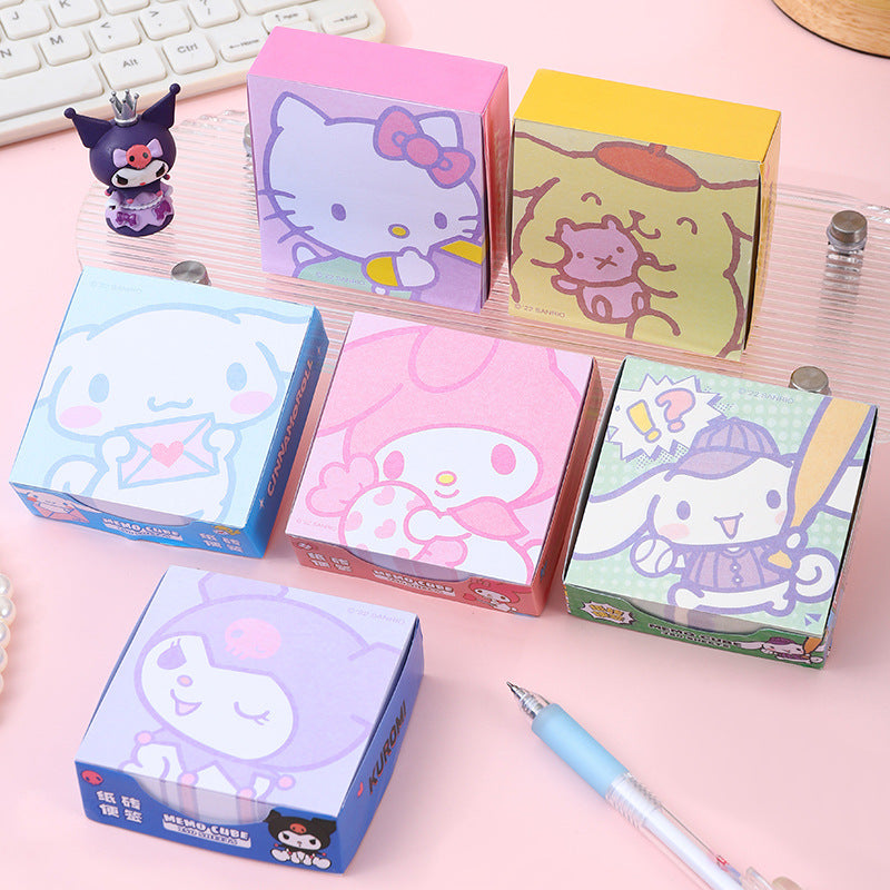 Pastel decorative memo note pads displayed with a blue stationery pen