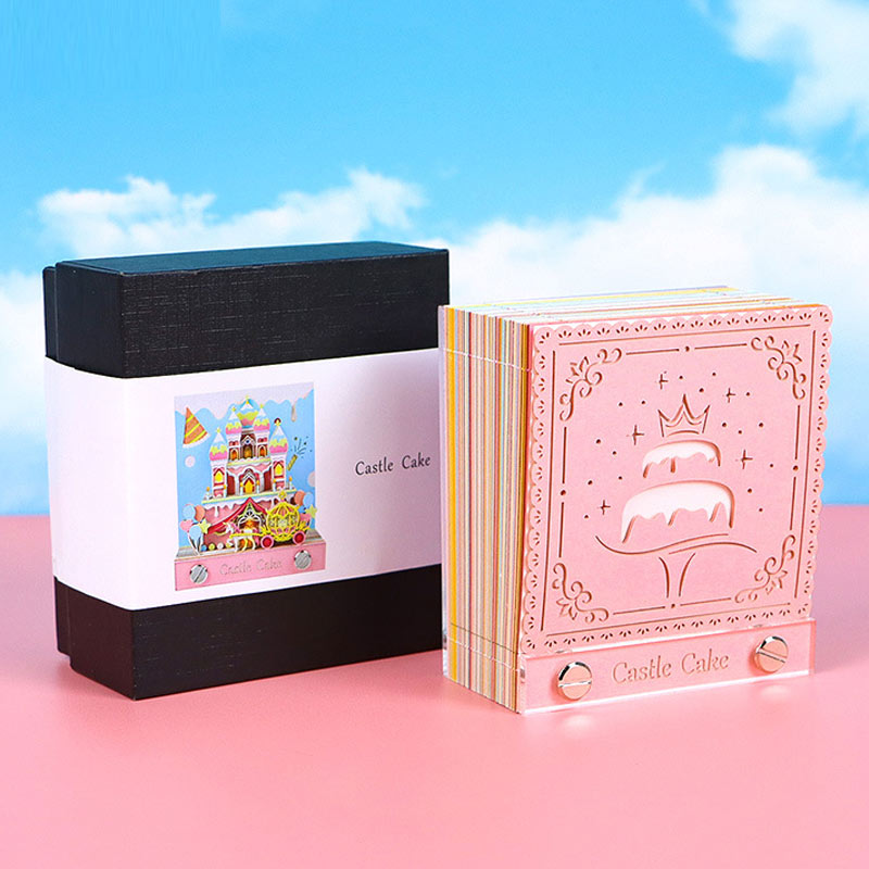 Pink 3D castle note pad displayed beside its decorative gift packaging