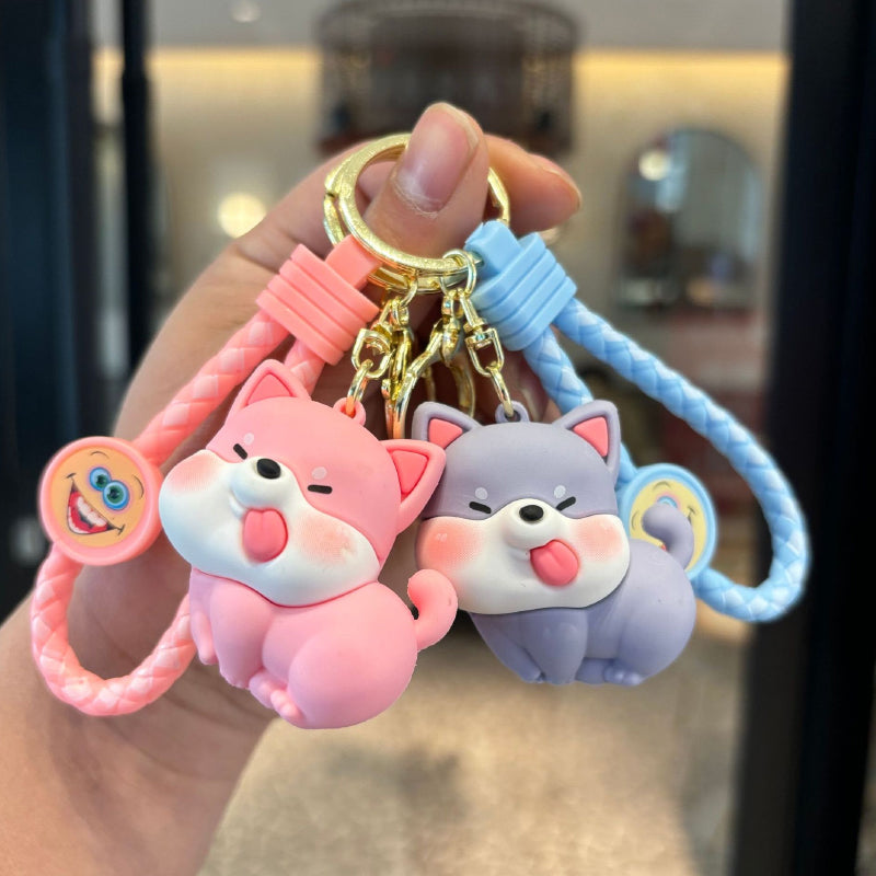 Pink and blue dog figurine keychains with braided straps