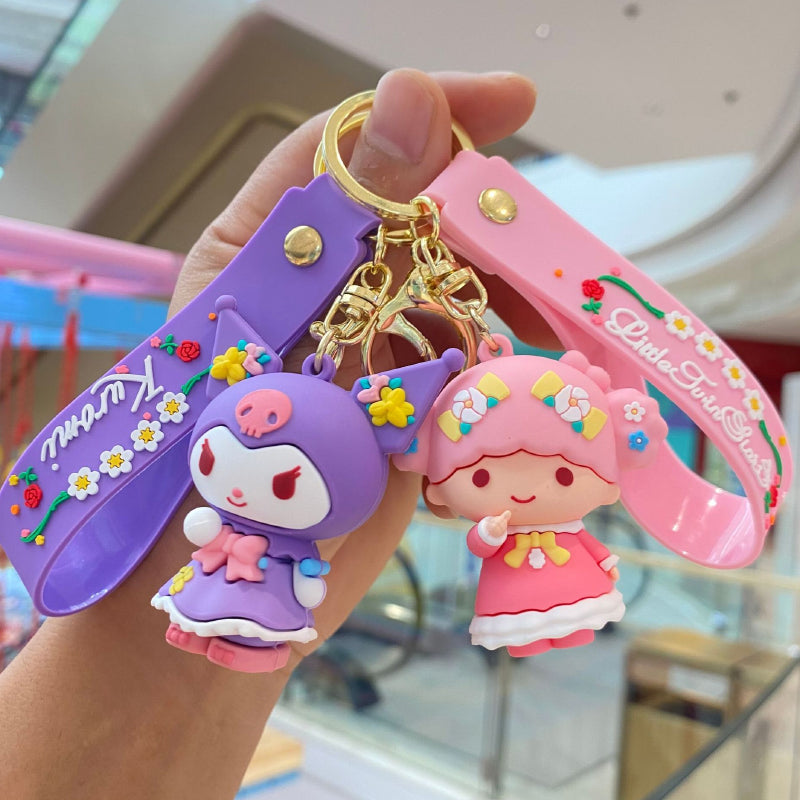 Pink and purple floral doll keychains with decorative straps