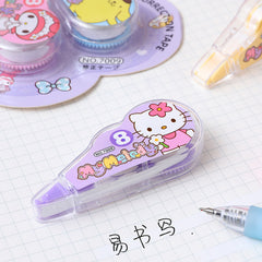 Purple cartoon correction tape dispenser on a notebook