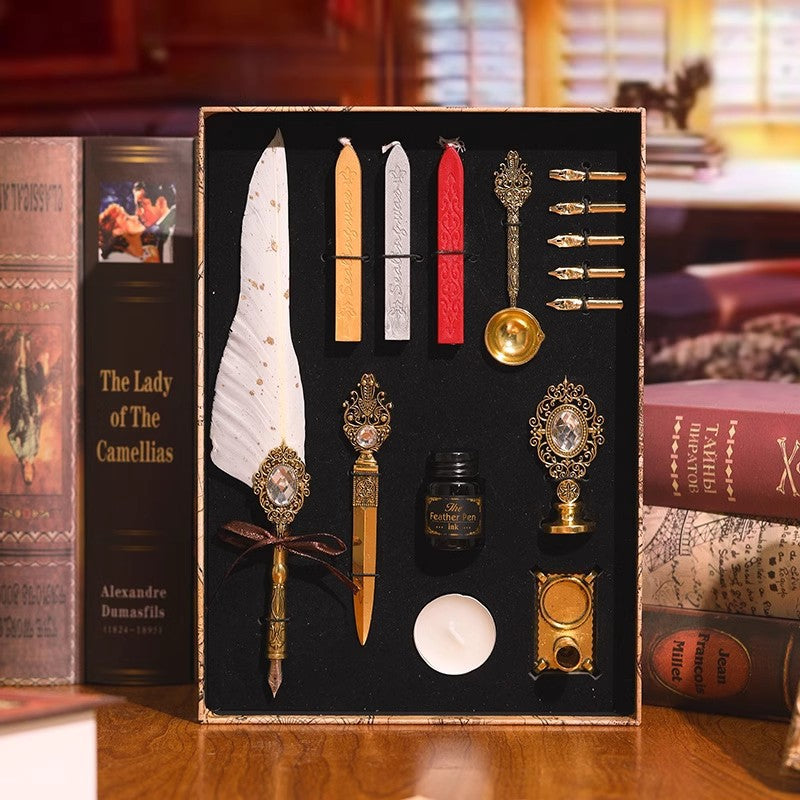 Vintage feather quill and wax seal set with ink, nibs and candle