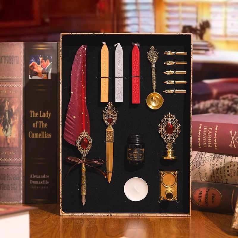 Red feather quill gift set with sealing wax sticks and gold accessories