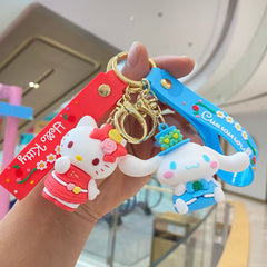 Red and blue doll keychains with floral straps and metal rings