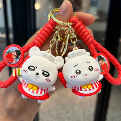 Red dessert pet keychain pair with white figures, braided straps, and gold-tone rings