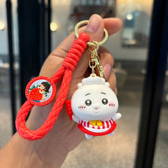 Red and white dessert pet keychain with braided strap and gold-tone clasp