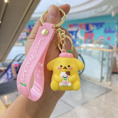 Yellow character keychain with pink decorative strap